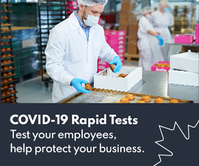 An employee working in a kitchen while wearing a mask and gloves, above the words COVID-19 rapid tests. Test your employees, help protect your business.