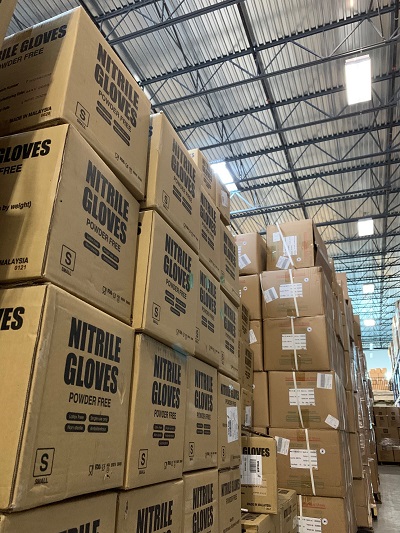 Boxes of nitrile gloves are stacked together, to be delivered through the Protecting Our People initiative