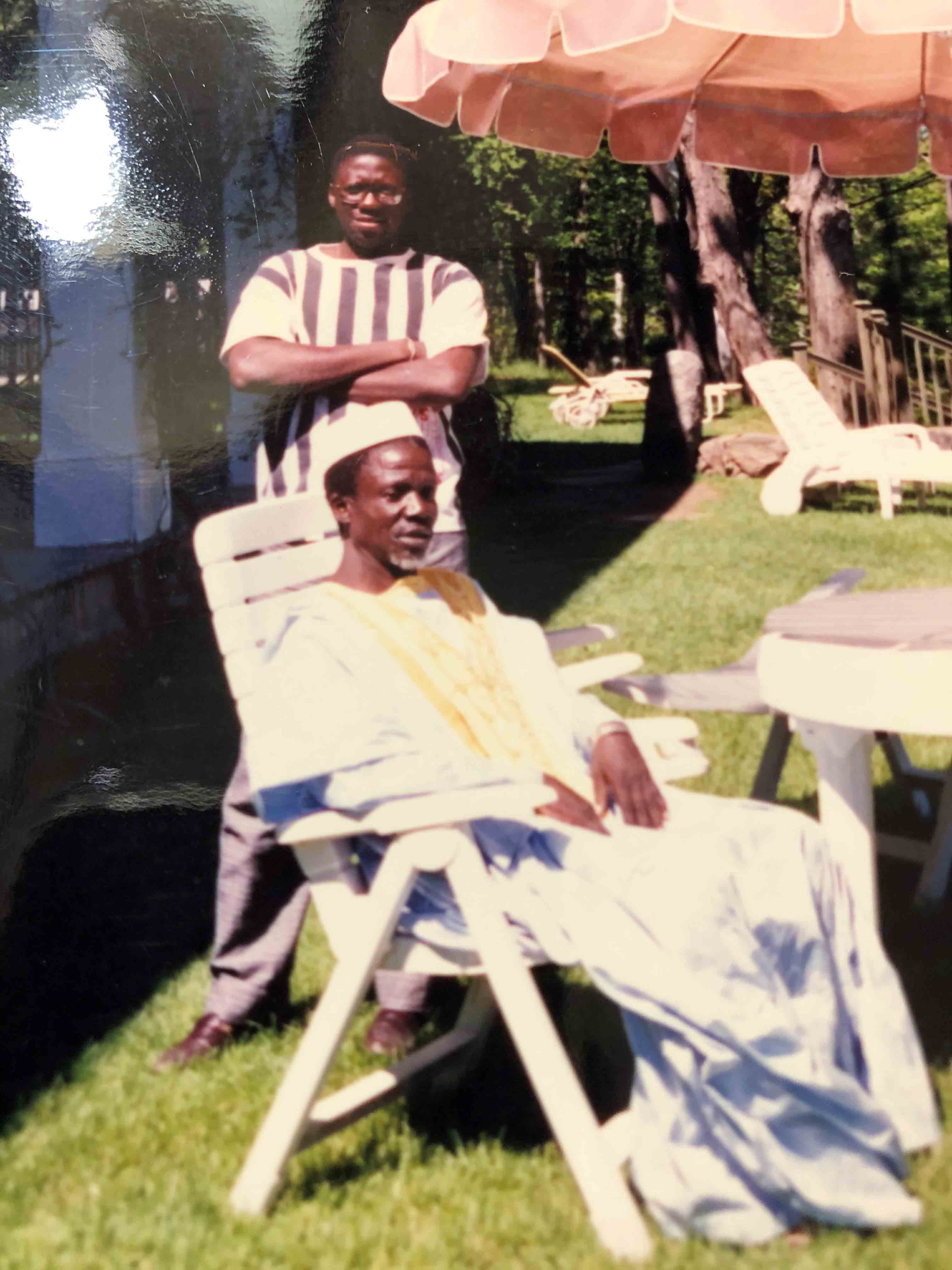 Moussa standing behind his father who visited him in Sherbrooke, Quebec