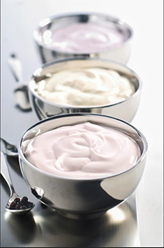 Close-up of three bowls of stirred yogurts