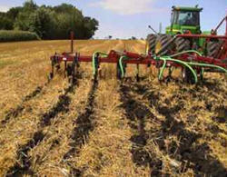Photo shows a field being seeded using an air-seeder with a minimum of soil disturbance.