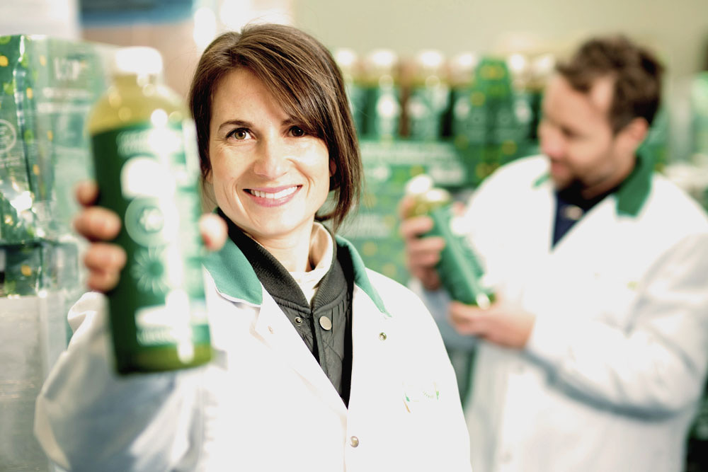 Julie Poitras-Saulnier holding a LOOP juice towards the camera