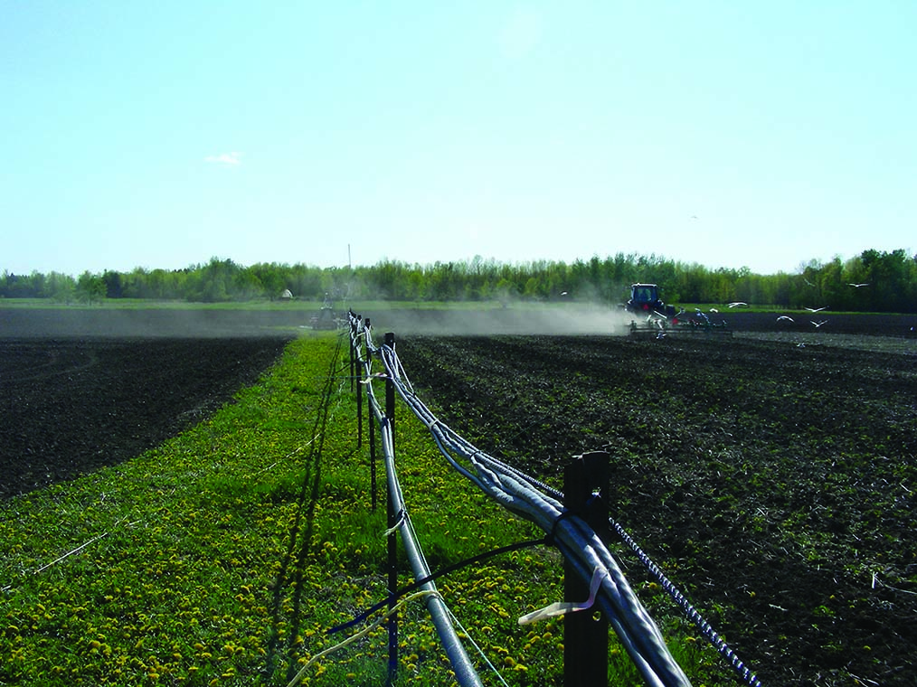 Image displays the land preparation during tillage and the resulting soil blowing in the wind across the fields.